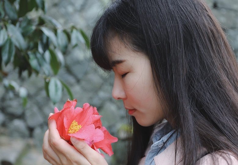 Woman smelling flower